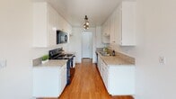 Located in Torrance, CA, this single-story unit offers a well-organized layout with a practical mix of flooring, natural light, and functional finishes throughout. The floor plan, visible in the 3D overview, reveals a thoughtfully arranged interior with distinct living, sleeping, kitchen, and bathroom zones.

The galley kitchen is a standout feature, lined with white cabinetry on both sides and topped with granite-style countertops. Black appliances, including an electric range and microwave, complement the clean aesthetic, while warm hardwood-style flooring and overhead track lighting add character and practicality.

The living area is generously proportioned, featuring plush neutral carpeting and a wide sliding glass door fitted with vertical blinds that draw in natural light and provide access to an outdoor view. The textured ceiling carries throughout the carpeted rooms, contributing a consistent residential feel.

Bedrooms are bright and well-sized, each with vertical-blind-covered windows that allow ample natural light. The neutral carpet and white walls create a clean, versatile canvas.

Two bathrooms serve the unit. One features a granite-topped vanity with white cabinetry, a large mirror, and a combination tub and shower. The second includes a walk-in shower with sliding glass doors, a granite vanity, and hardwood-style flooring, offering a polished, cohesive finish.