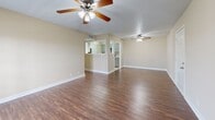 Located at 179 N Royal Oaks Blvd in Franklin, TN, this single-floor, two-bedroom, one-bathroom residence offers a practical and comfortable layout. The open living area is anchored by rich hardwood-style flooring and features ceiling fans throughout, creating a bright and airy atmosphere. French doors in the living room allow natural light to pour in while providing outdoor access. The kitchen connects seamlessly to the living space via a pass-through window, and is equipped with stainless steel appliances—including a gas range, microwave, dishwasher, and refrigerator—complemented by gray cabinetry and tile flooring. Both bedrooms are carpeted and well-sized, each featuring ceiling fans and closets with double-panel doors. The primary bedroom offers a generous footprint with ample closet storage and windows that bring in natural light. The bathroom is finished with tile flooring, a tiled tub-shower combination, and brushed nickel fixtures. A central hallway connects the bedrooms and bathroom, contributing to an efficient and functional floor plan. The textured ceilings and neutral warm-toned walls provide a clean, move-in ready canvas throughout the home.