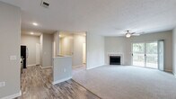Located at 8800 Bradwell Pl in Fishers, Indiana, this well-appointed 2-bedroom, 2-bathroom single-floor home offers a practical and comfortable layout with modern finishes throughout. The open-concept living and kitchen area serves as the heart of the home, where wood-look hard flooring transitions into plush carpeting in the living room. A tile-surround fireplace anchors the living space, which is further highlighted by a ceiling fan and a sliding glass door that opens onto a private outdoor deck, filling the room with natural light and outdoor views. The kitchen features rich dark cabinetry, light stone countertops, a classic white subway tile backsplash, and a full suite of stainless steel appliances, including a range, microwave, and dishwasher. A peninsula provides additional prep space and separates the kitchen from the main living area. Both bedrooms are generously sized with plush carpet, ceiling fans, and natural light from window treatments. The spacious primary bedroom includes a large walk-in closet outfitted with wire shelving on three sides for ample storage. The bathrooms offer clean, neutral finishes, with one featuring a tub-shower combination with white tile surround and wood-look flooring. Additional highlights include three closets, a utility room, and a thoughtful single-floor layout ideal for easy everyday living.