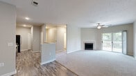 Located at 8800 Bradwell Pl in Fishers, Indiana, this well-appointed 2-bedroom, 2-bathroom single-floor home offers a practical and comfortable layout with modern finishes throughout. The open-concept living and kitchen area serves as the heart of the home, where wood-look hard flooring transitions into plush carpeting in the living room. A tile-surround fireplace anchors the living space, which is further highlighted by a ceiling fan and a sliding glass door that opens onto a private outdoor deck, filling the room with natural light and outdoor views. The kitchen features rich dark cabinetry, light stone countertops, a classic white subway tile backsplash, and a full suite of stainless steel appliances, including a range, microwave, and dishwasher. A peninsula provides additional prep space and separates the kitchen from the main living area. Both bedrooms are generously sized with plush carpet, ceiling fans, and natural light from window treatments. The spacious primary bedroom includes a large walk-in closet outfitted with wire shelving on three sides for ample storage. The bathrooms offer clean, neutral finishes, with one featuring a tub-shower combination with white tile surround and wood-look flooring. Additional highlights include three closets, a utility room, and a thoughtful single-floor layout ideal for easy everyday living.