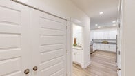 Located at 48 White Crescent Cir in Hardeeville, SC, this single-story, 2-bedroom, 2-bathroom home offers a clean, modern aesthetic with thoughtful design details throughout. The open-concept living area is bright and welcoming, featuring light wood-look flooring, a ceiling fan, and large windows that invite natural light and outdoor views. The space flows seamlessly into a well-designed kitchen outfitted with crisp white shaker cabinets, granite countertops, a center island with sink, stainless steel appliances, and recessed lighting — ideal for both everyday cooking and entertaining. Both bedrooms are comfortably sized, finished with plush carpet, ceiling fans, and natural light from windows with blinds. The primary bedroom is a generous retreat, complemented by ample closet space — one of six closets found throughout the home. The bathrooms feature white vanities with granite countertops and a full tub-shower combination. A dedicated laundry room adds everyday convenience. The home's neutral color palette, consistent finishes, and efficient single-floor layout make it a practical and attractive residence in the Hardeeville area.