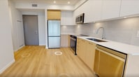 This contemporary 600 square foot apartment in Richmond offers a well-designed living space with two bedrooms and one bathroom. The open-concept layout maximizes the use of space, creating a seamless flow between the living areas. Large windows in the bedrooms and living room flood the space with natural light and provide stunning city views.

The kitchen is a highlight, featuring sleek white and wood-tone cabinetry, stainless steel appliances, and under-cabinet lighting. The bathroom boasts a modern design with a marble-look floor, glass shower enclosure, and wood vanity.

Throughout the apartment, light-colored walls and pale wood flooring create a bright, airy ambiance. The primary bedroom, measuring 120 square feet, offers ample space for a comfortable retreat. The second bedroom, while smaller, is versatile and could serve as a guest room or home office.

The apartment's single floor layout enhances accessibility and includes a hallway connecting the various rooms. With its modern finishes, efficient use of space, and urban views, this apartment presents an attractive option for those seeking contemporary city living in Richmond.