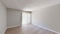 Located at 4400 Elkhorn Blvd in Sacramento, CA, this single-story, one-bedroom, one-bathroom unit offers a practical and efficiently organized layout. Throughout the space, light wood-look flooring and neutral gray walls create a clean, cohesive aesthetic, complemented by white baseboards and textured ceilings.

The combined kitchen and living room area forms the heart of the unit. The living room features a sliding glass door fitted with vertical blinds, allowing natural light to filter in while providing access to the outdoors. The kitchen is well-appointed with ample white cabinetry, dark countertops, a dishwasher, a refrigerator, a range, and a microwave. A peninsula countertop adds additional workspace and separates the kitchen from the living area. A window above the sink brings in additional natural light.

The bedroom is a comfortably sized private retreat featuring corner windows with vertical blinds that invite natural light from multiple angles. A closet provides dedicated storage within the unit.

The full bathroom includes a tub/shower combination with a white surround, a toilet, and a vanity with countertop space. A hallway connects the main living areas to the bedroom and bathroom, completing the functional flow of this well-maintained unit.