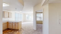 Located at 1533 Meadow Peak View in Colorado Springs, CO, this single-floor, 2-bedroom, 2-bathroom residence offers a practical and well-organized layout. The open-concept living and dining area is bathed in natural light through large windows dressed with vertical blinds, and features neutral-toned carpet throughout. A glass-panel door provides additional light and outdoor access from the living room.

The kitchen is positioned adjacent to the living area and features light wood cabinetry with ample storage, laminate countertops, tile flooring, and white appliances including a refrigerator, electric range, and range hood. A kitchen peninsula offers additional counter space and separates the kitchen from the living area.

Both bedrooms are carpeted and feature windows that allow natural light. The spacious primary bedroom includes a closet, while the second bedroom is well-sized with its own window and closet access. Each bedroom offers a calm, neutral palette with cream-colored walls.

The bathrooms include a full tub-shower combination finished with clean white square tile. The dedicated laundry room is equipped with washer and dryer hookups, wire shelving for storage, and tile flooring, adding everyday convenience to the home.