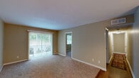 Located at 1246 Mooty Bridge Rd in LaGrange, Georgia, this single-floor 2-bedroom, 2-bathroom residence offers a functional and comfortable layout across a thoughtfully arranged floor plan. Warm beige walls and textured ceilings carry throughout the home, creating a cohesive and inviting atmosphere.

The living room is a welcoming space featuring plush carpeting and a sliding glass door fitted with vertical blinds that opens onto a private balcony with views of lush greenery. Adjacent to the living room, the dining area features hardwood flooring and an elegant chandelier overhead, ideal for everyday meals or entertaining.

The galley-style kitchen is efficiently designed with rich wood cabinetry, a tile backsplash, granite-style countertops, and full appliances including a range and refrigerator. Hardwood flooring continues through this area, adding warmth and durability.

Both bedrooms are carpeted and filled with natural light from large windows overlooking the surrounding greenery. The primary bedroom offers a generous footprint along with dedicated closet space. Each of the two bathrooms includes a full tub and shower combination with clean white tile surrounds and wood-toned vanity cabinetry. Additional closets throughout provide ample storage for everyday living.