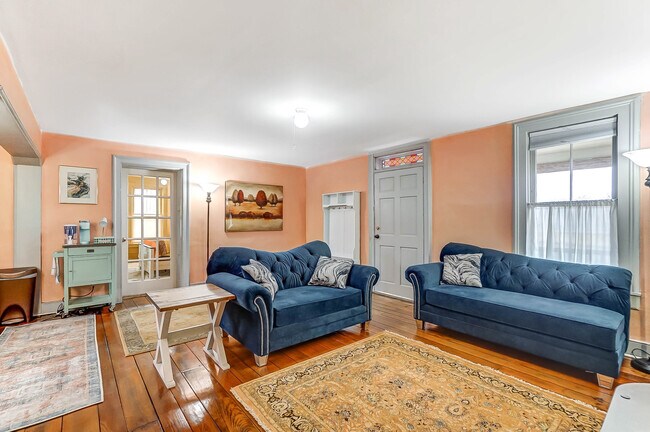 Original wood floors with new rugs and furniture - 705 Deacon St