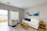 Located on Garfield Road in Clinton Township, Michigan, this single-floor, 2-bedroom, 1-bathroom residence offers a thoughtfully designed layout with a clean, contemporary aesthetic throughout. The living room welcomes with warm neutral tones, light wood-style flooring, large windows dressed in sheer curtains, and a sliding door that opens to a private patio, filling the space with natural light. The open-concept kitchen and dining area is outfitted with stainless steel appliances, a dishwasher, sleek taupe cabinetry, white quartz countertops, recessed lighting, and a peninsula that accommodates casual dining. The primary bedroom is generously sized, while the second bedroom offers versatile space suitable as a guest room or home office. Both rooms feature plush carpeting, ample natural light, and closet storage. The bathroom provides a clean, modern finish with a wood-toned vanity, illuminated mirror, tile flooring, and a dedicated walk-in shower. Additional highlights include three closets for abundant storage, a hallway connecting all rooms, and an in-unit laundry area for added convenience. The overall ambiance is bright, neutral, and move-in ready.