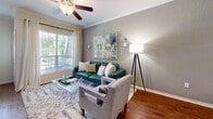 Located at 500 Trinity Ln N in Saint Petersburg, FL, this single-story, one-bedroom, one-bathroom residence offers a thoughtfully designed layout with a comfortable and functional flow. The open-concept kitchen and living room area serves as the heart of the home, featuring rich hardwood flooring, crown molding, and a ceiling fan. The kitchen is outfitted with white cabinetry, granite countertops, stainless steel appliances including a full-size refrigerator, microwave, and range, as well as a tile backsplash and a wine cooler — ideal for everyday cooking and entertaining. A curved granite-topped peninsula provides additional counter space and visual separation from the living area. The living room receives generous natural light through large windows with views of lush greenery, complemented by a built-in display cabinet and neutral, calming tones. The bedroom is a serene retreat with plush carpeting, a ceiling fan, and a large window that fills the room with natural light. A dedicated closet adds practical storage. The bathroom includes a combination tub and shower, a granite vanity, and hardwood flooring, maintaining the refined aesthetic found throughout the home. A hallway and entrance complete the well-organized floor plan of this inviting residence.