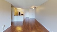 This single-floor residence at 12092 Adrian St in Garden Grove, California offers a well-organized layout with distinct living, kitchen, and sleeping areas. The open-concept living and dining area is finished with warm hardwood-style flooring that runs throughout the main space, complemented by a ceiling fan with light fixture overhead and a textured ceiling. A sliding glass door with vertical blinds leads to a private balcony, allowing natural light to fill the room.

The kitchen is positioned adjacent to the living area and features a peninsula counter with granite-style countertops, white cabinetry, stainless steel refrigerator, a range, and a dishwasher. Under-cabinet lighting adds warmth to the workspace. A six-panel door connects the kitchen area to the carpeted bedroom, which includes a window with a view of greenery, providing a quiet and comfortable retreat. Additional closet storage is visible in the main area.

The bathroom is equipped with wood-style flooring, an extended vanity with granite-style countertops, white cabinetry, a well-lit mirror, and brushed nickel fixtures. The unit presents a clean, functional interior throughout.