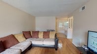 This single-floor residence at 3993 Cottage Hill Rd offers a well-organized layout with distinct living, dining, kitchen, sleeping, and bathroom areas. The living room is a generously sized space finished with warm hardwood-style flooring and a textured ceiling, receiving natural light through a window fitted with blinds. The room flows openly toward the dining area, creating a connected and functional common space.

The dining area features tile flooring, a window for natural light, and a pendant light overhead, with a set of closet doors providing additional storage. The kitchen is outfitted with rich, dark wood cabinetry extending to the upper walls, offering abundant storage. It includes a double sink, a range with overhead ventilation, and tile flooring, making it a practical and efficient workspace.

The bedroom is carpeted and comfortably sized, featuring a wide double bi-fold closet that provides ample storage space, along with a ceiling fan for climate comfort. The bathroom is clean and straightforward, with tile flooring, a shower-tub combination, vanity with sink, and bright white walls that contribute to a light, open feel throughout the space.