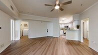 Located in Temple Terrace, Florida, this single-story, 3-bedroom, 2-bathroom home offers a clean, modern aesthetic throughout. Wide-plank wood-look flooring runs consistently across every room, lending warmth and visual continuity to the entire floor plan.

The open living room is bright and airy, featuring crown molding, a ceiling fan, and a large window that invites natural light and outdoor views. The kitchen is well-equipped with crisp white cabinetry, granite-style countertops, stainless steel appliances including a refrigerator, range, and microwave, and wood-look flooring that carries seamlessly from the living area.

The spacious primary bedroom includes a ceiling fan and connects to a private en-suite bathroom featuring a walk-in glass-door shower, a granite-topped vanity with white cabinetry, and open shelving. A second full bathroom offers a tub-shower combo with white tile surround and a matching granite vanity. Two closets provide ample storage, including a walk-in closet with wire shelving. Additional bedrooms are generously sized, each with a ceiling fan and natural light from wide windows. A dedicated laundry room houses a full-size washer and dryer. The hallway connects all areas efficiently, completing this thoughtfully designed home.