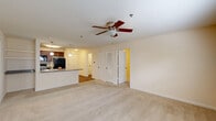 Located at 359 N West St in Indianapolis, Indiana, this single-floor, 2-bedroom, 2-bathroom residence offers a well-organized and comfortable layout. The open-concept living and kitchen area serves as the heart of the home, where plush carpeting and a ceiling fan create a relaxed atmosphere. The kitchen is equipped with rich dark wood cabinetry, granite countertops, a large peninsula with a double-basin sink, pendant lighting, and black appliances including a refrigerator, range, and microwave. The peninsula flows seamlessly into the living space, making it ideal for everyday living and entertaining.

The primary bedroom is a generously sized retreat, featuring soft carpeting, a ceiling fan, and a spacious walk-in closet with wire shelving systems that maximize storage. The second bedroom is carpeted as well and benefits from natural light through a window with blinds. Both bathrooms feature rich wood-toned cabinetry and durable wood-look flooring. One bathroom includes a corner glass-enclosed shower stall and a tall storage cabinet.

Additional highlights include three closets throughout the unit, a dedicated laundry area, and a utility room. The neutral color palette and consistent finishes throughout lend the space a cohesive and move-in-ready appeal.