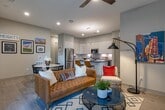 Located in Houston's vibrant Heights neighborhood, this single-floor residence at 401 W 25th St offers a thoughtfully designed layout with contemporary finishes throughout. The kitchen is a standout feature, equipped with stainless steel appliances including a gas range, built-in microwave, and full-size refrigerator. Sleek white cabinetry extends to the ceiling for ample storage, complemented by quartz countertops, a classic subway tile backsplash, and light wood-style flooring that flows seamlessly through the living areas. The open floor plan connects the kitchen to the dining and living spaces, creating an inviting atmosphere for everyday living and entertaining. Multiple bedrooms offer plush carpeting, neutral tones, and sliding glass doors that open directly onto private balconies with outdoor views. The primary suite includes access to a luxurious en-suite bathroom featuring dual vanities with backlit mirrors, a large glass-enclosed walk-in shower with floor-to-ceiling tile, and a soaking tub. A secondary bathroom mirrors the same refined aesthetic with a tub-shower combination and illuminated vanity. A dedicated laundry area with full-size side-by-side washer and dryer units, topped by additional cabinetry, adds practical convenience to this well-appointed home.
