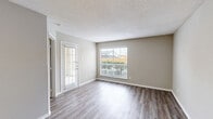 Located at 6315 Central City Blvd in Galveston, TX, this one-bedroom, one-bathroom unit offers a well-organized single-floor layout designed for comfortable everyday living. The open-concept living room and kitchen area form the heart of the space, with durable wood-look laminate flooring and neutral-toned walls creating a clean, cohesive aesthetic throughout. A glass-paneled front door and multiple windows fitted with blinds allow natural light to fill the living area, enhancing its bright and airy feel.

The kitchen is thoughtfully appointed with warm-toned cabinetry, granite-style countertops, a tiled backsplash, and a peninsula that provides additional counter space and separation from the living area. A full suite of black and stainless steel appliances, including a range, microwave, dishwasher, and refrigerator, complete the kitchen.

The bedroom offers a comfortable footprint, accented by a ceiling fan with light fixture and a window that continues the natural light theme. A closet provides dedicated storage. The bathroom features tile flooring, a granite-topped vanity with wood cabinetry, and a full tub/shower combination with tile surround. Textured ceilings are consistent throughout the unit.