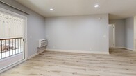 Located at 6317 Monterey Rd in the vibrant Highland Park neighborhood of Los Angeles, this 2-bedroom, 1-bathroom single-floor unit offers a thoughtfully updated interior with a clean, contemporary aesthetic throughout. Light-toned luxury vinyl plank flooring runs continuously across the entire space, creating a cohesive and airy feel from room to room. The open living area is bright and welcoming, featuring recessed lighting, a wall-mounted AC unit, and a sliding glass door that opens to a private patio, filling the space with natural light and outdoor connectivity. A ceiling fan adds comfort to the combined living and dining area. The kitchen is well-appointed with white shaker cabinetry, stainless steel appliances including a gas range, dishwasher, and refrigerator, along with a mosaic tile backsplash and light stone countertops that extend to a peninsula — ideal for casual dining or meal prep. Both bedrooms feature soft blue-gray walls, natural window light, and ample floor space. The primary bedroom comfortably accommodates standard furnishings. The full bathroom is finished cleanly with a tub-shower combination and matching light flooring. This unit presents a move-in ready, modernized living space in a well-connected LA neighborhood.