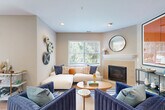 Located at 4 Liberty Ln in South Portland, Maine, this well-appointed 2-bedroom, 2-bathroom single-floor residence offers a thoughtfully designed layout with warm, contemporary finishes throughout. Light hardwood flooring flows seamlessly across the entire home, creating a cohesive and inviting atmosphere.

The open-concept living area is anchored by a classic fireplace and large windows that flood the room with natural light and views of surrounding greenery. The kitchen features modern stainless steel appliances including a gas range, sleek wood-toned cabinetry, under-cabinet lighting, and clean white countertops. A built-in desk nook provides a convenient workspace. The dining area connects directly to an outdoor patio via sliding glass doors, bringing in additional natural light and outdoor views.

Both bedrooms are generously proportioned, each featuring windows with lush tree views, ceiling fans, and warm neutral tones. The primary bedroom includes a dedicated walk-in closet with built-in shelving for ample storage. The bathrooms are well-appointed, with one featuring a distinctive neo-angle glass-enclosed shower. A dedicated laundry area houses a full stacked washer and dryer unit. The home combines functional design with modern comfort in a serene South Portland setting.