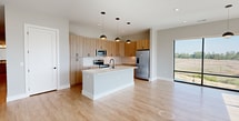 Located at 4362 Watermark Dr in Wilmington, NC, this modern single-story home offers 1,640 square feet of thoughtfully designed living space across 3 bedrooms, 2 bathrooms, and 3 closets. The open-concept kitchen and living area serve as the heart of the home, featuring light wood cabinetry, a large white quartz island with an undermount sink, stainless steel appliances, a subway tile backsplash, and stylish dome pendant lighting — all set atop warm light wood flooring. The bedrooms are carpeted and finished with soft neutral tones, ceiling fans, and ample natural light. The primary bedroom spans 210 square feet and connects to a private bathroom featuring a glass-door shower, light wood vanity, and matte black fixtures. A second full bathroom includes a tub-shower combo with matte black hardware, a framed mirror, and matching wood cabinetry. Three well-organized closets with built-in shelving and hanging rods provide generous storage throughout. A standout feature is the private balcony accessible via large sliding glass doors, offering breathtaking panoramic views of the surrounding waterway and marshlands — a true highlight of this Wilmington coastal property.