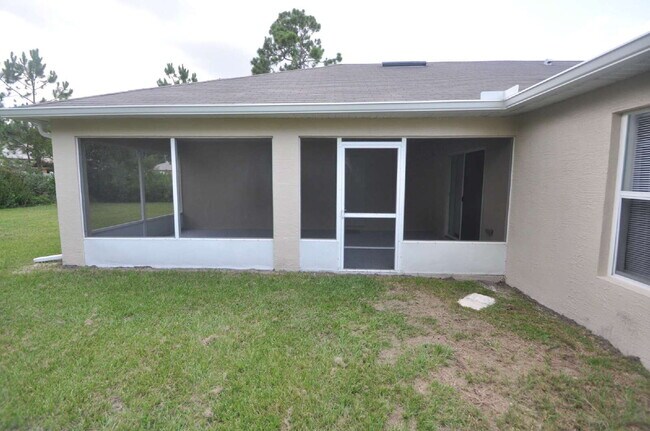 Building Photo - "Spacious 4-Bed Oasis in Palm Coast – Your...