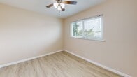 Located at 1180 Saranap Avenue in Walnut Creek, CA, this efficiently designed one-bedroom, one-bathroom unit offers a thoughtful layout across a single floor. The space is finished with warm, light-toned wood-style flooring throughout the main living and bedroom areas, complemented by neutral beige walls that create a bright and welcoming atmosphere.

The bedroom is a comfortable, well-proportioned room featuring a ceiling fan with integrated lighting, clean white baseboards, and a window with blinds that invites natural light and offers views of surrounding greenery. A dedicated closet provides convenient storage.

The kitchen is outfitted with white cabinetry, a gas range, dishwasher, and a full-size refrigerator. Light ceramic tile flooring and a window with natural light make this a functional and pleasant cooking space.

The bathroom features a stand-alone glass-enclosed shower stall with chrome framing, a toilet, and a vanity with white cabinetry, all set on wood-style flooring for a clean, cohesive look.

The unit's simple, efficient design and neutral palette provide a versatile canvas, while its Walnut Creek location offers access to the area's amenities, dining, and transit options.