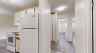 Located at 255 Stillwater Dr in Saskatoon, Saskatchewan, this 2-bedroom, 1-bathroom residence offers a practical and well-organized single-floor layout. The living area is bright and open, featuring neutral carpet flooring, a sliding glass door that leads to a private balcony, and a wall-mounted air conditioning unit — providing comfortable indoor-outdoor connectivity and year-round climate control. Textured ceilings and neutral warm-toned walls carry throughout the unit, creating a cohesive aesthetic.

Both bedrooms are carpeted and feature built-in closets with sliding doors, offering generous storage. The primary bedroom is a comfortable size with a dedicated closet and window, while the second bedroom also benefits from natural light and its own closet with open shelving.

The bathroom is clean and functional, featuring a full soaker tub and shower surround, a vanity with white cabinetry, a large mirror, and wood-look vinyl flooring. A dedicated laundry room provides added convenience, complete with built-in shelving and wood-look flooring — a practical feature not always found in similarly sized homes. A central hallway connects all rooms efficiently, and the kitchen area is equipped with a full-sized refrigerator. This unit provides a comfortable, functional living space in a residential Saskatoon neighbourhood.