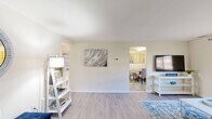 Located at 1260 Rossiter Ave in Baltimore, MD, this single-floor, 2-bedroom, 1-bathroom residence offers a well-organized layout that makes efficient use of its space. The living room features light hardwood-style flooring, a large window with valance treatments that invite natural light, and neutral walls that create a calm, welcoming atmosphere. Adjacent to the living room, the dining area accommodates a round table and seating, accented by colorful wall art and a window that brightens the space. The kitchen is equipped with warm wood cabinetry, ample counter space, a gas range, full-size refrigerator, dishwasher, and a skylight overhead that enhances the sense of openness. The spacious primary bedroom offers generous closet storage with multiple built-in closet sections, light flooring, and windows for natural light. The second bedroom is similarly well-appointed with carpeted flooring, a window, and comfortable proportions. Both bedrooms feature neutral walls suitable for personalization. The full bathroom includes a tiled tub/shower combination, tile flooring, and a wood-toned vanity. A connecting hallway ties the layout together, and the entryway includes a glass-panel door and closet, providing a functional transition into the home.