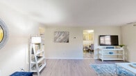 Located at 1260 Rossiter Ave in Baltimore, MD, this single-floor, 2-bedroom, 1-bathroom residence offers a well-organized layout that makes efficient use of its space. The living room features light hardwood-style flooring, a large window with valance treatments that invite natural light, and neutral walls that create a calm, welcoming atmosphere. Adjacent to the living room, the dining area accommodates a round table and seating, accented by colorful wall art and a window that brightens the space. The kitchen is equipped with warm wood cabinetry, ample counter space, a gas range, full-size refrigerator, dishwasher, and a skylight overhead that enhances the sense of openness. The spacious primary bedroom offers generous closet storage with multiple built-in closet sections, light flooring, and windows for natural light. The second bedroom is similarly well-appointed with carpeted flooring, a window, and comfortable proportions. Both bedrooms feature neutral walls suitable for personalization. The full bathroom includes a tiled tub/shower combination, tile flooring, and a wood-toned vanity. A connecting hallway ties the layout together, and the entryway includes a glass-panel door and closet, providing a functional transition into the home.