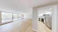 Located at 5 Stonehill Dr in Stoneham, MA, this 2-bedroom, 2-bathroom single-floor residence offers a well-designed layout with a clean, contemporary aesthetic. The open-concept living and dining area is a standout feature, showcasing light hardwood-style flooring, neutral toned walls, and a generous wall of sliding glass doors that flood the space with natural light and provide views of the surrounding greenery. Baseboard heating runs throughout, ensuring comfort year-round. The kitchen is thoughtfully appointed with crisp white cabinetry, light quartz-style countertops, stainless steel appliances including a dishwasher, range, microwave, and refrigerator, recessed lighting, and a window overlooking the outdoors. Both bedrooms are carpeted and offer a calm, neutral palette with natural light; the spacious primary bedroom includes a window with wooded views and a dedicated closet with built-in shelving. The two bathrooms are finished with tile flooring, white vanities, and stone-topped counters. A hallway connects the private areas of the home, and a dedicated closet provides additional storage. The overall ambiance is bright, fresh, and move-in ready.