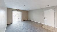 This well-designed apartment at 813 Archway Ct in Virginia Beach offers 1060 square feet of comfortable living space. The layout includes three bedrooms, two bathrooms, a kitchen, living room, closet, and hallway, all on a single floor. The primary bedroom is generously sized at 180 square feet, providing a spacious retreat.

The interior showcases a neutral color palette with soft gray carpeting in the living areas and bedrooms, creating a cohesive and calming atmosphere. The kitchen is a highlight, featuring modern white cabinetry, granite countertops, and stainless steel appliances. A breakfast bar adds functionality and separates the kitchen from the living space.

Large windows, including an eye-catching arched window in one room, flood the apartment with natural light. Sliding glass doors in the living area lead to an outdoor space, extending the living area. The bathrooms are tastefully appointed with clean lines and modern fixtures.

The property's exterior offers ample parking and is surrounded by mature trees, providing a pleasant residential setting. This apartment combines comfort, style, and convenience in a desirable Virginia Beach location.