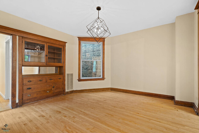 Spacious, formal dining room with chandelier - 2323 N Albany Ave
