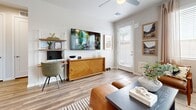 Located in Phoenix's North Valley, this thoughtfully designed one-bedroom, one-bathroom unit offers a cohesive modern aesthetic across its single-story layout. Wood-look plank flooring runs consistently throughout, providing a warm, unified foundation for each space.

The open-concept kitchen and living area forms the heart of the unit. The kitchen features white shaker cabinetry, quartz countertops, stainless steel appliances, and a central island with seating for two — ideal for casual dining. Recessed lighting and a window above the sink bring in natural light. The kitchen connects directly to a door providing outdoor access.

The living room is bright and inviting, with multiple windows dressed in blinds and drapes that allow generous natural light. A ceiling fan and a secondary door to the outdoor patio area add functionality to the space.

The bedroom is a comfortable retreat, featuring a two-tone accent wall, a ceiling fan, and a window with outdoor views of surrounding landscape. A dedicated closet and a hallway connect the bedroom to the full bathroom.

The bathroom is cleanly appointed with a white vanity, quartz countertop, a glass-enclosed walk-in shower, and a window for additional ventilation and light. The overall ambiance of the unit is clean, modern, and efficiently organized.