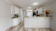 Located at 4058–4064 E 133rd St in Chicago's Hegewisch neighborhood, this single-story home offers a thoughtfully designed layout with a clean, contemporary aesthetic throughout. Wood-look tile flooring flows seamlessly from room to room, contributing to a cohesive and low-maintenance interior.

The kitchen is a standout feature, showcasing an abundance of white shaker-style cabinetry paired with granite-look countertops and a central island that provides additional prep space and casual seating. Black Whirlpool appliances, including a gas range with over-the-range microwave and a refrigerator, complete the well-equipped cooking space. The layout opens toward a bright window, allowing natural light to fill the area.

The bedrooms are comfortably sized, each finished with the same wood-look flooring, neutral wall paneling, and windows that bring in natural light and outdoor views. Crown molding details add a refined touch to the living spaces.

Both bathrooms are outfitted with granite-top white vanities, full soaking tubs with shower surrounds, and clean white fixtures. The primary bathroom includes access to a walk-in closet with built-in shelving. Additional storage is provided by a hallway closet with classic six-panel white doors. The home's consistent finishes and bright, neutral palette create a welcoming and move-in-ready atmosphere throughout.