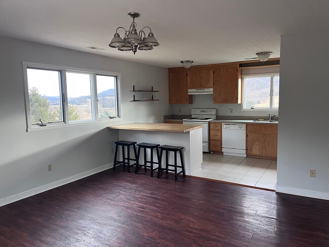 Open kitchen/living area with kitchen island that adds great counter space and storage. - 2353 Lusters Gate Rd