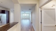This contemporary loft apartment at Vintage Lofts offers 980 square feet of thoughtfully designed living space. The open-concept floor plan maximizes the use of space, creating a seamless flow between rooms. Large windows in the living areas and bedrooms flood the apartment with natural light, while providing scenic views of the surrounding area.

The kitchen is a highlight, featuring sleek dark wood cabinetry, stainless steel appliances, and ample counter space. It opens directly to the living area, perfect for entertaining. Both bedrooms are generously sized, with the primary bedroom measuring 140 square feet. Each bedroom has its own closet space for storage.

The apartment boasts two full bathrooms, both finished with modern fixtures and tiled surfaces. A separate laundry room with full-sized washer and dryer adds convenience to daily living.

Throughout the apartment, you'll find high-quality finishes such as wood-look flooring, ceiling fans, and recessed lighting. The neutral color palette provides a blank canvas for personal decor styles.

With its thoughtful layout, modern amenities, and attention to detail, this Vintage Lofts apartment offers a comfortable and stylish urban living experience. The combination of open spaces and private areas creates a versatile home suitable for various lifestyles.