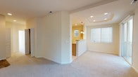 Located at 725 North Center Parkway in Kennewick, Washington, this single-floor residence offers a well-organized layout with a warm, neutral color palette throughout. The living room is a standout space, featuring plush carpeting, a tile-surround fireplace, a large picture window with views of surrounding trees, and access to a private outdoor balcony through sliding glass doors — bringing in abundant natural light and a sense of openness.

The galley-style kitchen is efficiently designed with warm wood cabinetry, tile flooring, a double sink, white appliances, and tile backsplash accents. A breakfast bar with pendant lighting connects the kitchen to the adjoining dining and living areas, topped with a tray ceiling that adds architectural interest.

The bedrooms are carpeted and generously sized, each offering closet storage. The primary suite includes a dedicated vanity area with wood cabinetry and direct access to a walk-in closet. A full bathroom features tile flooring, a tub-shower combination with glass doors, and a wood-cabinet vanity. An additional bathroom provides a built-in shelving closet for added storage convenience.

Recessed lighting and consistent neutral tones throughout create a clean, cohesive atmosphere well-suited for comfortable everyday living.