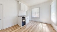 Located at 729 S Union Ave in the heart of Los Angeles, CA, this compact single-floor studio unit offers an efficient and thoughtfully arranged living space. The open layout is unified by warm-toned light wood laminate flooring that runs throughout, lending a clean and modern aesthetic to the interior.

The kitchenette is positioned along one wall and features white cabinetry with a classic tile backsplash, a granite-style countertop with an integrated sink, and a compact refrigerator beneath the counter — providing all the essential cooking and storage necessities within a minimal footprint.

Natural light filters generously into the main living area through a large window dressed with vertical blinds, creating a bright and airy atmosphere. A classic cast-iron radiator situated beneath the window provides reliable in-unit heating. The textured white ceiling and crisp white walls throughout contribute to an overall sense of openness.

The bathroom is neatly appointed with a full-size soaking tub and shower combination, finished in clean white with chrome fixtures, offering a functional and refreshing space. A vertical-blind window in the bathroom also allows for natural light while maintaining privacy.

The unit includes a solid entry door and ample wall space, making it a practical and manageable living space in a central Los Angeles location.