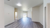 Located at Duportail St in Richland, WA, this single-floor, 2-bedroom, 2-bathroom residence offers a well-organized and functional layout. The open living area features smooth hardwood-style flooring and is bathed in natural light through a large sliding glass door fitted with vertical blinds, offering views of the surrounding greenery outside.

The kitchen is efficiently designed with gray cabinetry accented by matte black hardware, white appliances including a refrigerator, dishwasher, and electric range with an overhead exhaust hood, and light-toned countertops. The wood-look flooring continues seamlessly from the living area into the kitchen.

Both bedrooms are carpeted for comfort, with the primary bedroom offering generous proportions and its own closet. The second bedroom features a bright window overlooking the outdoors. Each bedroom benefits from its own dedicated closet space.

The two bathrooms are clean and straightforward in design, each featuring a full tub-shower combination with white surrounds and chrome fixtures. A hallway connects the various rooms, providing a logical and easy-to-navigate flow throughout the home. Textured ceilings and neutral wall tones complete the clean, move-in-ready aesthetic of this Richland residence.