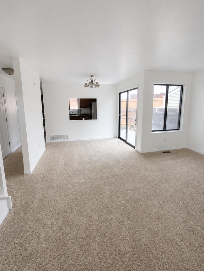 Photo - Convenient location, new paint & carpet throughout, enclosed patio. Townhome