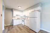 Located at 280 Montmorency Dr in Hamilton, Ontario, this two-storey, 3-bedroom, 2-bathroom home offers a practical and efficiently designed layout split evenly across two floors. The main level features a bright living room with wide, large-pane windows that flood the space with natural light and overlook a fenced backyard patio with mature trees — a welcoming outdoor retreat. Modern light-toned vinyl plank flooring runs throughout the main level, complementing the neutral grey and white colour palette.

The kitchen is well-appointed with white cabinetry, white appliances including a refrigerator, electric range, and built-in storage. It connects seamlessly to the living area, creating an open, functional flow. A carpeted staircase with a black metal railing leads to the lower level, which houses additional living and bedroom spaces finished with matching vinyl flooring.

The three bedrooms are clean and simply designed, with neutral walls and sliding mirrored closet doors that enhance the sense of space. The two bathrooms are functional, featuring vanities with mirrors and clean fixtures. Throughout the home, consistent light-toned finishes and textured ceilings contribute to a cohesive, move-in-ready aesthetic suitable for practical, everyday living.