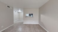 Located at 6203 Marinette Dr in Houston, TX, this single-story 2-bedroom, 1-bathroom home offers a practical and functional layout. Light neutral tones and large-format tile flooring run consistently throughout the space, creating a clean and cohesive look.

The living and dining areas are open and well-lit, with a picture window at the front of the home inviting natural light and outdoor views. A distinctive pass-through window with a granite-style ledge connects the dining area to the kitchen, which features dark cabinetry and decorative patterned tile backsplash. This design detail enhances connectivity between the two spaces.

The primary bedroom is generously sized and includes a ceiling fan with light fixture and a window for natural ventilation. The second bedroom is a comfortable, versatile space also finished with the same tile flooring. A dedicated closet provides additional storage. A hallway connects the bedrooms to the full bathroom, which is appointed with a dark-stained wood vanity featuring granite countertops and a full tub-shower combination dressed in large-format marble-look tile — a standout detail that adds a refined touch. The home's straightforward layout and consistent finishes make it an efficient and easy-to-navigate space.