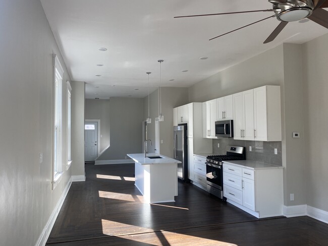 The living room, kitchen, and dining room are setup as a modern open concept living space - 308 Center St