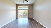 Located at 800 Reliant Way in American Canyon, California, this well-appointed 2-bedroom, 1-bathroom residence offers a thoughtfully designed single-level layout. The open-concept kitchen and living area serves as the heart of the home, showcasing rich dark wood cabinetry, stainless steel appliances including a gas range, microwave, and refrigerator, complemented by a stylish subway tile backsplash and light quartz countertops with a breakfast bar. Hardwood-style flooring runs throughout the main living areas, adding warmth and continuity to the space. The living room features soaring ceilings, a ceiling fan, and a sliding glass door that opens to a private balcony, bringing in abundant natural light and outdoor views of the surrounding greenery. Both bedrooms are carpeted for comfort and feature large windows with blinds that frame pleasant outdoor views. The spacious primary bedroom includes tall ceilings and direct access to the hallway connecting to the full bathroom. The bathroom is equipped with a full-size soaking tub and shower combination with built-in shelving and clean white finishes. A connecting hallway ties all rooms together efficiently, completing this functional and modern residential layout.