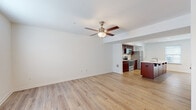 Located at 511 N Burhans Blvd in Hagerstown, Maryland, this two-floor residence offers a clean, contemporary design with a consistent finish palette throughout. The main living area is open and airy, featuring light hardwood-style flooring and a ceiling fan overhead. This space flows directly into the kitchen, which serves as a functional centerpiece of the home. The kitchen is equipped with rich, dark-toned cabinetry, a full suite of stainless steel appliances including a refrigerator, electric range, and built-in microwave, as well as a generous island with a light quartz countertop and an integrated sink. Recessed lighting illuminates the space, and windows allow natural light to fill the room.

The bedrooms are located on the upper floor and feature plush carpeting, ample closet space with built-in shelving, and windows fitted with blinds. Each room maintains a neutral, bright palette well-suited for a variety of uses. The bathrooms mirror the kitchen's design sensibility, showcasing the same rich cabinetry paired with white quartz countertops, light wood-look flooring, and brushed nickel fixtures. One bathroom includes a full soaking tub with a shower, while another features a dual-sink vanity. Throughout both floors, clean white walls and consistent trim work contribute to a cohesive, well-maintained aesthetic.