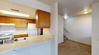 Located at 1421 Jack Pine Way in Kalamazoo, Michigan, this two-story home offers five bedrooms and two full bathrooms spread across two generously sized floors. The layout is both practical and accommodating, with nearly equal square footage on each level connected by a central staircase.

The kitchen is designed with functionality in mind, featuring warm oak cabinetry, light countertops, a double-basin sink, a white electric range, and a full-size refrigerator. A pass-through counter opens the kitchen toward the adjacent living area, enhancing the sense of openness on the main floor. Tile flooring anchors the kitchen space, while plush carpeting flows throughout the hallways, bedrooms, and common areas on both levels.

Each of the five bedrooms is well-proportioned, with neutral walls, carpet flooring, and windows fitted with vertical blinds that allow for natural light. Several bedrooms include closets with built-in rods for convenient storage. The generously sized primary bedroom offers ample space for a full furniture arrangement.

Both bathrooms are finished with oak vanities, light countertops, large mirrors, and full tub-shower combinations with tile flooring. The hallways connecting the rooms on each floor are wide and clearly defined, contributing to an organized and easy-to-navigate floor plan throughout the home.