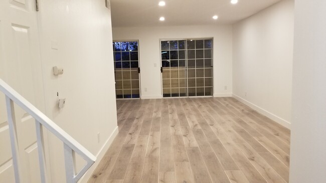 Living Room with Double Sliding Balcony Doors. - 14126 Tiara St