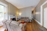 Located at 111 Osmun Pl in Ithaca, NY, this single-floor, 3-bedroom, 1-bathroom home blends classic character with functional living spaces. The living room serves as a welcoming centerpiece, showcasing warm hardwood floors, high ceilings, and a charming brick fireplace with a white painted mantel — a standout architectural detail that adds timeless appeal. Natural light flows in through tall windows, enhancing the room's open, comfortable atmosphere.

The spacious primary bedroom features gleaming hardwood floors, bright white walls, and generous ceiling height, lending an airy, restful quality. A distinctive bedroom includes a beautiful bay window with a built-in bench seat, a classic radiator, and ample natural light, giving it a unique and inviting character.

The kitchen is well-equipped with rich wood cabinetry, granite-style countertops, a stainless steel gas range, dishwasher, and refrigerator, all set on light wood-tone flooring. The bathroom has been tastefully updated with large stone-look tile, a decorative mosaic accent border, and a full soaking tub with shower.

Three connecting hallways provide a functional flow throughout the home, complemented by a dedicated closet. This property offers a warm blend of historic charm and practical amenities in a convenient Ithaca location.