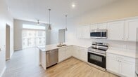 This contemporary apartment, located at 900 3rd St SE in Cedar Rapids, Iowa, offers a harmonious blend of style and functionality within its 920 square feet. The open-concept design creates a seamless flow between living spaces, enhancing the sense of spaciousness. The kitchen is a standout feature, boasting pristine white cabinetry, gleaming countertops, and high-end stainless steel appliances, including a built-in microwave and electric range.

Both bedrooms are generously sized, with the primary bedroom measuring 160 square feet. Each room features plush carpeting, large windows for natural illumination, and ample closet space. The two full bathrooms are fitted with modern fixtures and wood-look flooring, ensuring both comfort and style.

Throughout the apartment, neutral tones dominate, creating a bright and airy atmosphere. The living areas benefit from wood-look flooring, adding warmth and durability. Strategically placed windows not only flood the space with natural light but also offer urban views, connecting the interior to its surroundings.

Additional features include ceiling fans for improved air circulation, recessed lighting, and window treatments for privacy. The apartment's thoughtful layout, with two hallways, ensures easy navigation and defines separate living zones within the open plan. This well-designed space offers a perfect balance of comfort and contemporary urban living.