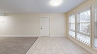Located at 26 Beacon St in Burlington, MA, this single-floor residence offers three bedrooms, two bathrooms, and a thoughtfully organized layout. The open-concept living and dining area is a standout feature, combining light tile flooring and plush carpeting to define separate zones within the expansive shared space. Multiple windows allow natural light to fill the room, creating a bright and welcoming atmosphere. Warm cream-toned walls and clean white trim carry throughout the home, lending a cohesive and neutral aesthetic.

The kitchen is well-appointed with white shaker-style cabinetry, granite countertops, a stainless steel dishwasher, and a range, all set atop light tile flooring. The layout provides ample counter and storage space, making it both functional and visually appealing.

The three bedrooms are carpeted and generously sized, with the primary bedroom offering notable square footage. Each bedroom features neutral walls and good natural light. Two closets provide practical storage solutions throughout the home.

Both bathrooms are finished in clean white tones, featuring tile flooring, vanities with white cabinetry, mirrors, and tub-shower combinations with tiled surrounds. The overall design of the home is clean, functional, and move-in ready.