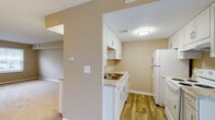 Located at 4592 Channing Ter in Columbus, Ohio, this two-story home offers a practical and comfortable layout spread across two floors. The main level features a welcoming living area with warm neutral-toned walls, plush carpeted flooring, and a large window fitted with blinds that allows natural light to fill the space. A staircase connects the levels, adding to the home's functional flow. The kitchen is outfitted with white cabinetry, granite-style countertops, a stainless steel sink, and white appliances including a full-size refrigerator, all set atop wood-look hard flooring that adds warmth to the space. The upper level includes generously sized bedrooms, each carpeted and painted in soft neutral tones, with windows providing natural light and views of the surrounding neighborhood. One bedroom features a built-in cabinet with countertop space, a ceiling fan, and sliding door access. The bathrooms are clean and functional — one features a tub-shower combo with white tile surround, wood-look flooring, and chrome fixtures, while another offers a vanity with a mirror and towel bar. The overall ambiance throughout is bright, clean, and move-in ready.