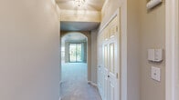 Located at 1520 North Beckley Avenue in Dallas, Texas, this single-story, 3-bedroom, 3-bathroom home offers a well-organized and functional layout. The living room serves as the heart of the home, featuring soaring ceilings, crown molding, neutral warm-toned walls, plush carpeting, and a classic wood-burning fireplace framed by a white mantel. An elegant arched passageway connects the living area to the rest of the home, lending architectural character throughout. The kitchen is well-appointed with light wood cabinetry, dark granite-style countertops, a center island, hardwood-style flooring, and a vaulted ceiling with track lighting and a decorative hanging pot rack, all complemented by a window that brings in natural light. Each of the three bedrooms features soft carpeting and windows that overlook greenery, providing a calm, private atmosphere. The primary bedroom includes crown molding, large multi-pane windows, and closet access. The bathrooms are clean and functional, featuring tiled tub surrounds, vanities with dark countertops, and large mirrors. Two closets provide ample storage, and four hallways ensure smooth circulation throughout the home.