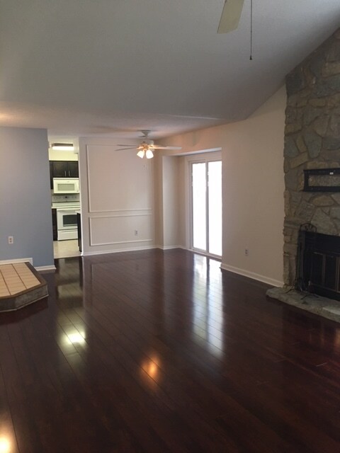 Dining room area with Hunter paddle fan, new slider patio doors with internal blinds, and wainscoting. - 9660 Windjammer